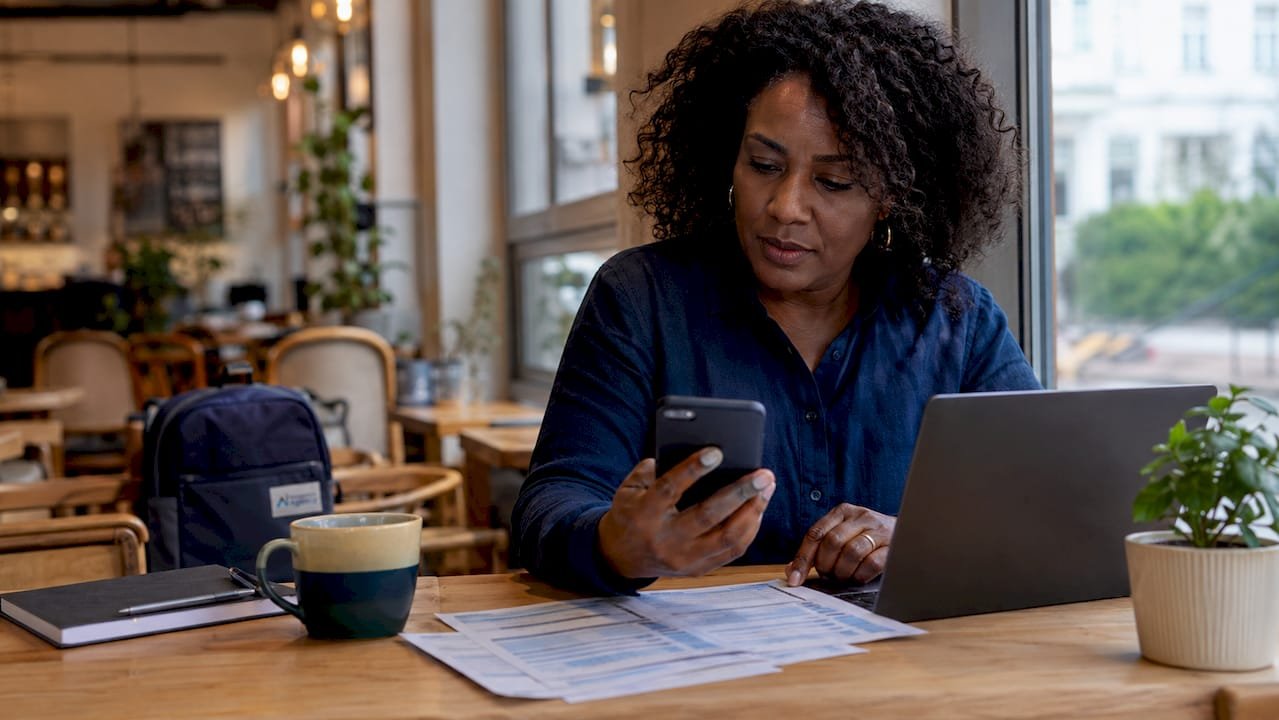Businesswoman using smartphone and documents